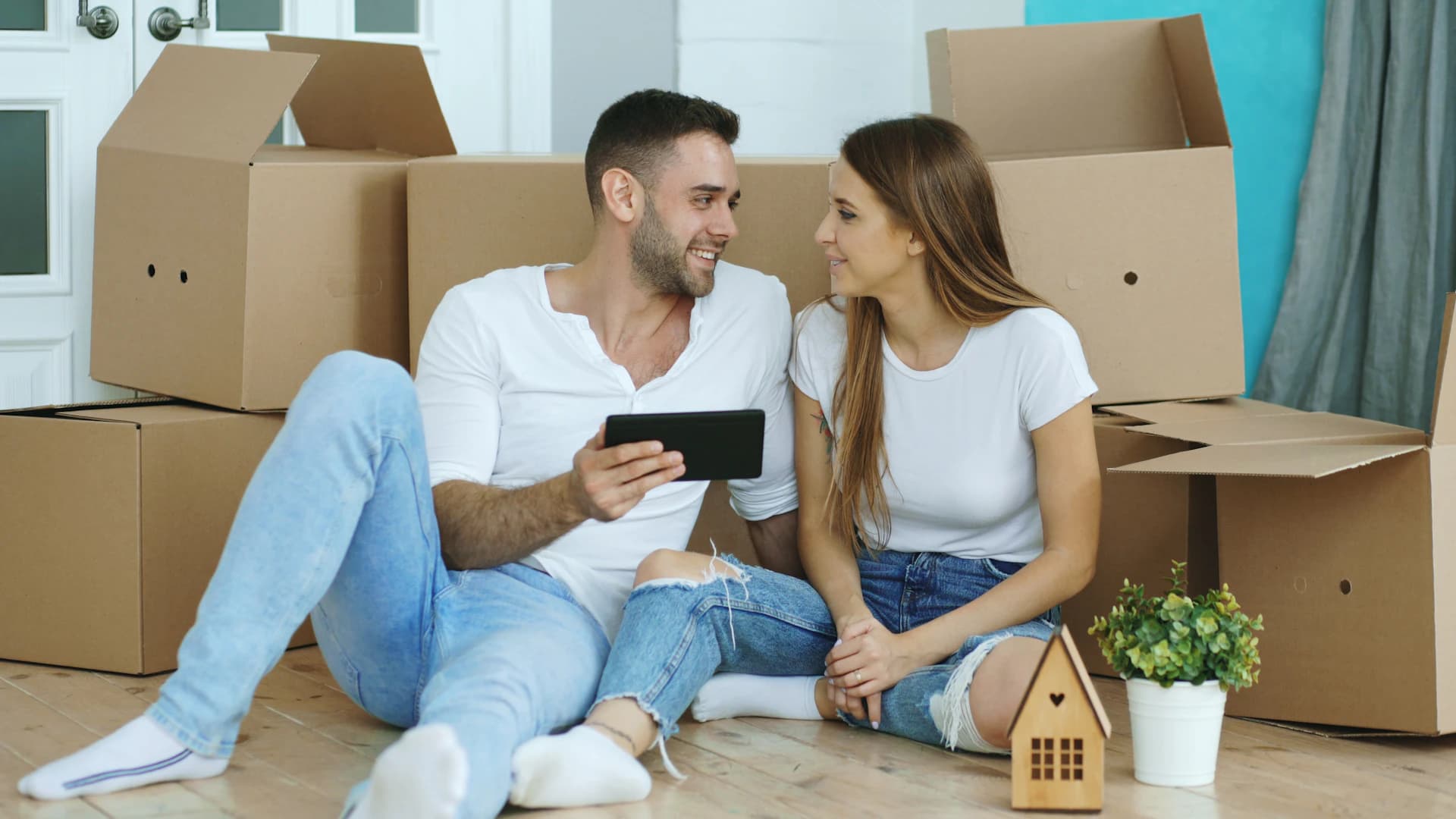 Couple planning their move surrounded by packed boxes